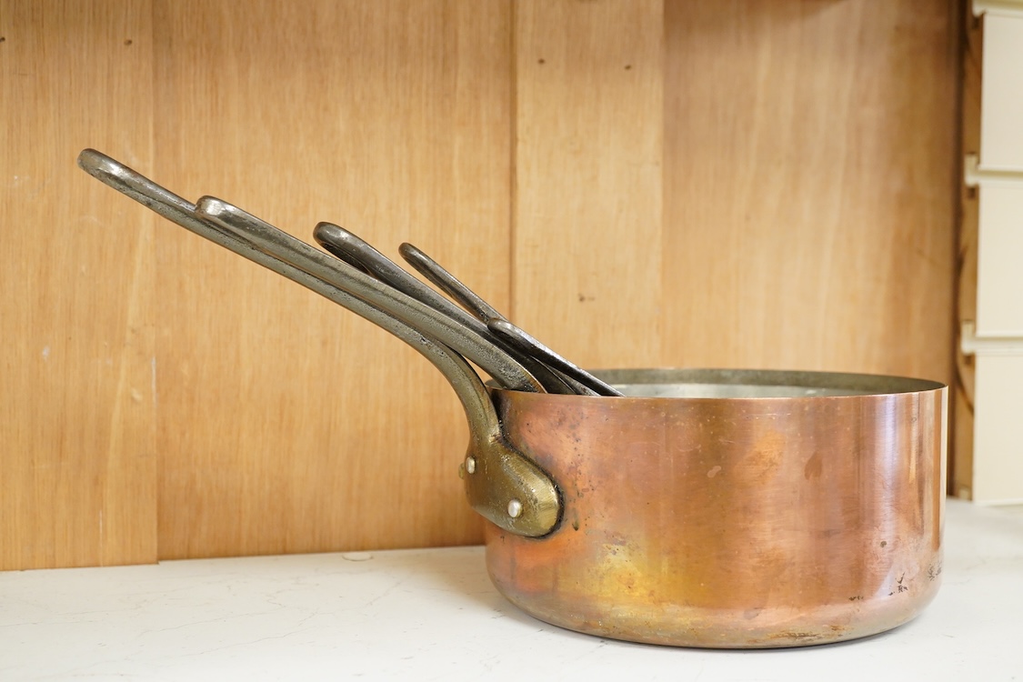 A graduated set five copper saucepans, signed Faucogney, largest 33cm wide